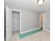 Bedroom with neutral carpet, closet with wire shelving, white trim, and a door leading to another room at 1934 N Arlington Ave, Indianapolis, IN 46218