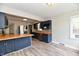 Open kitchen with stainless steel appliances, blue cabinets, butcher block counters, and hardwood floors at 1934 N Arlington Ave, Indianapolis, IN 46218