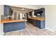 Spacious kitchen features blue cabinets, butcher block counters, stainless steel appliances, and hardwood floors at 1934 N Arlington Ave, Indianapolis, IN 46218