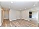 Open living room showcasing recessed lighting and new flooring that flows into an adjacent dining area at 1934 N Arlington Ave, Indianapolis, IN 46218
