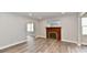 Bright living room featuring a fireplace, wood-look floors, and natural light at 1934 N Arlington Ave, Indianapolis, IN 46218