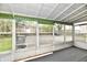 Enclosed sunroom with large windows, ample light, and an exterior view to the car park at 1934 N Arlington Ave, Indianapolis, IN 46218