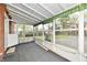 View of the enclosed sunroom featuring large windows, an open door and an exterior view at 1934 N Arlington Ave, Indianapolis, IN 46218