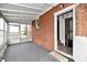 Enclosed sunroom with brick wall and doorway leading to a doorway at 1934 N Arlington Ave, Indianapolis, IN 46218