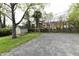 Lawn area with a small wooden shed and planting bed with a tree nearby at 1934 N Arlington Ave, Indianapolis, IN 46218