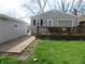 Relaxing backyard featuring a wooden deck, walkway, and well-manicured lawn at 2012 N Janney Ave, Muncie, IN 47304