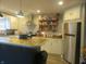 Well-lit kitchen with stainless steel refrigerator and white cabinetry at 2012 N Janney Ave, Muncie, IN 47304