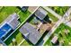 This aerial view of the home showcases a spacious yard, detached garage, trampoline and quiet neighborhood at 220 E Meridian St, Atlanta, IN 46031