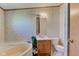 Bathroom with tub, toilet, and sink with decorative wallpaper at 220 E Meridian St, Atlanta, IN 46031