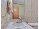 Bathroom featuring a tiled vanity area and decorative wallpaper at 220 E Meridian St, Atlanta, IN 46031