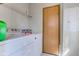 Laundry room with washer, dryer, overhead shelf, and door at 220 E Meridian St, Atlanta, IN 46031