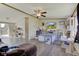 Open-concept living room with a ceiling fan, light gray flooring, and sliding glass door access at 220 E Meridian St, Atlanta, IN 46031