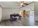Comfortable living room features light gray flooring, a ceiling fan, and ample natural light at 220 E Meridian St, Atlanta, IN 46031