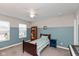 A sunny bedroom with two-tone painted walls, a wood frame bed, and a bookshelf at 2208 Dudley Ave, Westfield, IN 46074