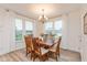 Sunlit dining room with wood table, six chairs, and large windows at 2208 Dudley Ave, Westfield, IN 46074