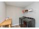 Functional laundry room with modern washer and dryer, storage shelves, and ample workspace at 2208 Dudley Ave, Westfield, IN 46074