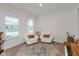 Bright living room featuring wood floors, piano, two armchairs, and natural light at 2208 Dudley Ave, Westfield, IN 46074