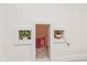 Hidden playroom behind white wall with shelving for decor or plants at 2208 Dudley Ave, Westfield, IN 46074