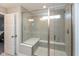 Modern shower stall with gray tiles, a built-in bench, and glass door at 2208 Dudley Ave, Westfield, IN 46074