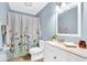 Charming bathroom featuring a floral shower curtain, a bright vanity, and ample lighting at 2214 Van Ness Pl, Indianapolis, IN 46240