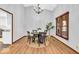 Cozy dining area featuring a modern chandelier, a circular table, and natural light from a large window at 2214 Van Ness Pl, Indianapolis, IN 46240