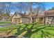 Attractive home with stone accents, a two-car garage, and a well-kept lawn with mature shade trees at 2214 Van Ness Pl, Indianapolis, IN 46240