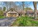 Charming single-story home featuring an attached garage and a well-maintained front yard with mature trees at 2214 Van Ness Pl, Indianapolis, IN 46240