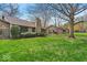 Well-maintained front lawn with mature trees and landscaping, enhancing curb appeal at 2214 Van Ness Pl, Indianapolis, IN 46240