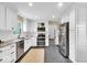 A well-lit kitchen featuring stainless steel appliances, granite countertops, and white cabinets at 2214 Van Ness Pl, Indianapolis, IN 46240