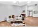 Airy living room boasting hardwood floors, a skylight, and comfortable seating arrangements at 2214 Van Ness Pl, Indianapolis, IN 46240