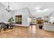Open-concept living room with hardwood floors, a fireplace, and large windows for plenty of natural light at 2214 Van Ness Pl, Indianapolis, IN 46240