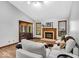 Bright living room showcasing a fireplace, hardwood floors, and access to the outdoors at 2214 Van Ness Pl, Indianapolis, IN 46240