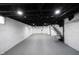 A look at the ample basement space with painted walls and ceiling and utility access at 2226 N Capitol Ave, Indianapolis, IN 46208
