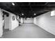 Spacious basement with white painted walls and black ceiling, offering potential for various uses at 2226 N Capitol Ave, Indianapolis, IN 46208