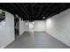 Unfinished basement features painted walls, exposed ceiling, and concrete flooring at 2226 N Capitol Ave, Indianapolis, IN 46208
