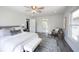Airy bedroom boasts ensuite bathroom access, decorative rug, and bench at the foot of the bed at 2226 N Capitol Ave, Indianapolis, IN 46208