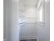 Walk-in closet featuring shelving, clothing rod, gray wood flooring, and a window at 2226 N Capitol Ave, Indianapolis, IN 46208