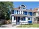 Inviting two-story home with a blue exterior, red front door, and landscaped front yard at 2226 N Capitol Ave, Indianapolis, IN 46208