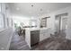 Spacious kitchen island with a farmhouse sink and open layout to the living areas with abundant natural light at 2226 N Capitol Ave, Indianapolis, IN 46208