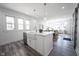 Open concept kitchen with a large island, farmhouse sink, and views into the adjacent living area at 2226 N Capitol Ave, Indianapolis, IN 46208