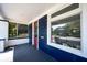 Charming porch with blue walls, a red door, and views of the landscaped yard at 2226 N Capitol Ave, Indianapolis, IN 46208