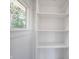 Closet shelving and a sunlit view from the window at 2226 N Capitol Ave, Indianapolis, IN 46208