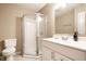 Bright bathroom featuring a glass enclosed shower, a white vanity, and a toilet at 2316 N Pennsylvania St # 1, Indianapolis, IN 46205