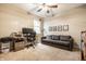 Comfortable bedroom featuring a ceiling fan, desk with monitor, and cozy gray sofa at 2316 N Pennsylvania St # 1, Indianapolis, IN 46205
