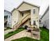 Rear exterior showing a wooden staircase, a grill, a garden, and yellow siding at 2316 N Pennsylvania St # 1, Indianapolis, IN 46205