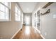 Bright hallway with natural light, wood floors, French doors, and a bench, creating a welcoming atmosphere at 2316 N Pennsylvania St # 1, Indianapolis, IN 46205