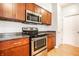 Well-equipped kitchen featuring stainless steel appliances, wood cabinets, and granite countertops, perfect for cooking enthusiasts at 2316 N Pennsylvania St # 1, Indianapolis, IN 46205