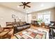 Well-lit living room with modern decor, ceiling fan, and leather furniture at 2316 N Pennsylvania St # 1, Indianapolis, IN 46205