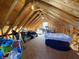Unfinished attic space with exposed rafters and plywood flooring, great for storage at 2419 N Park Ave, Indianapolis, IN 46205