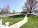 Landscaped backyard featuring a grassy lawn and white picket fence, creating a serene outdoor space at 2419 N Park Ave, Indianapolis, IN 46205